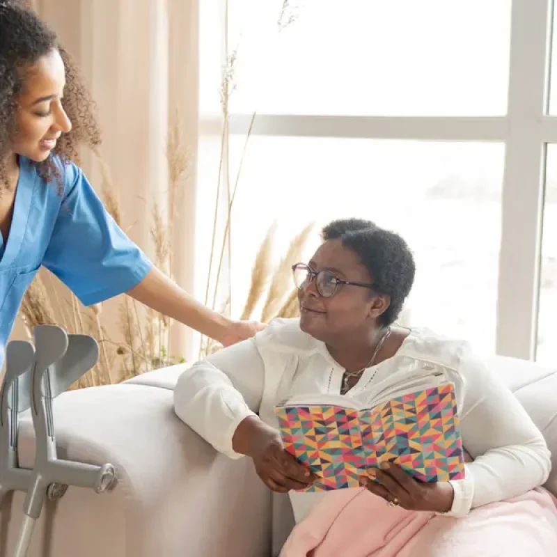 Care professional sharing a cup of tea with a client
